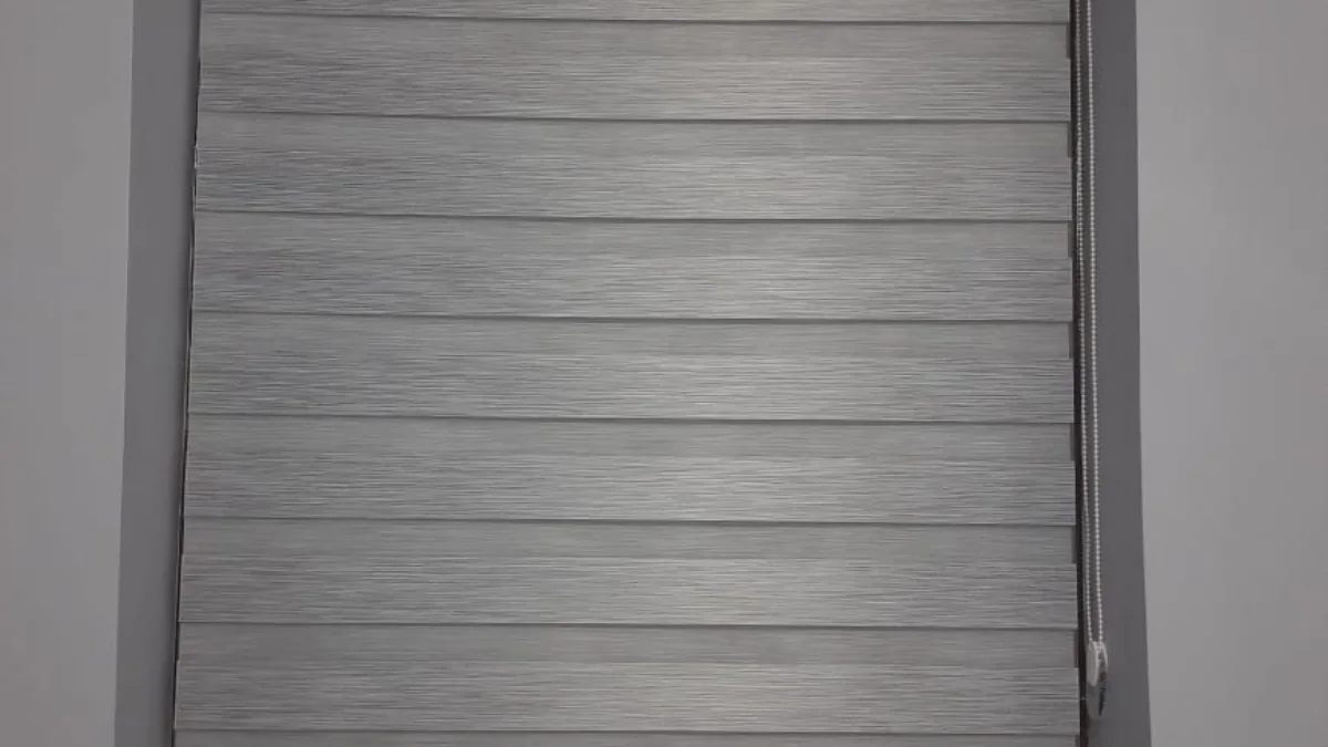 Neat roller blind covering a window in a modern room